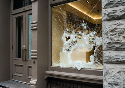Office window showing broken glass by vandals